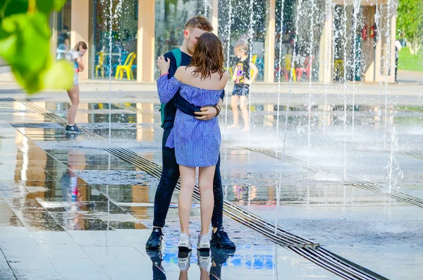 Boy and girl in fountain.
