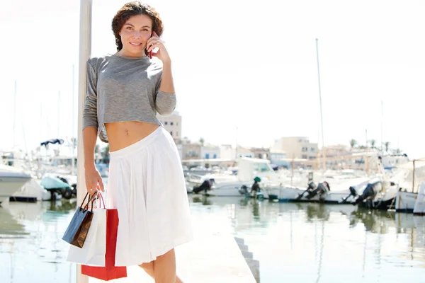 Woman with shopping bags and  smartphone