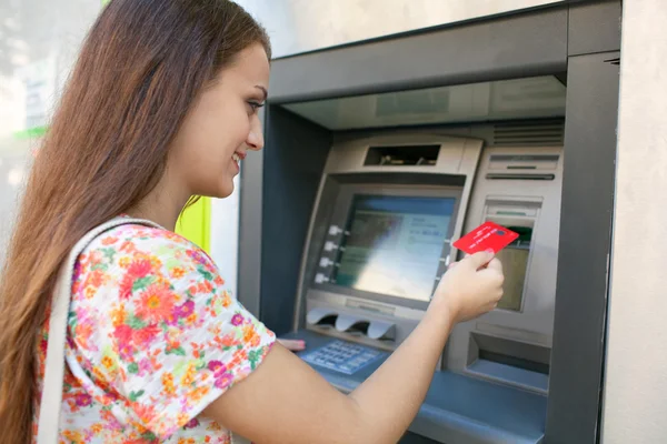 Woman using a cash point machine