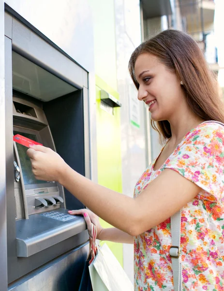 Woman using a cash point machine