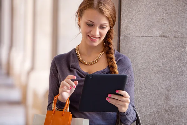 Woman with shopping bags and digital tablet