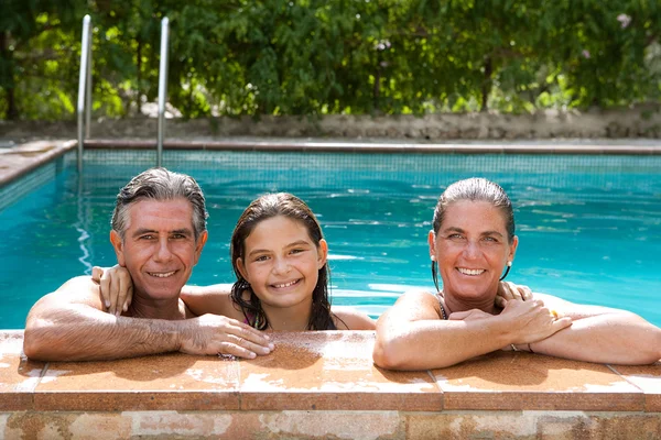 Family relaxing in a swimming pool