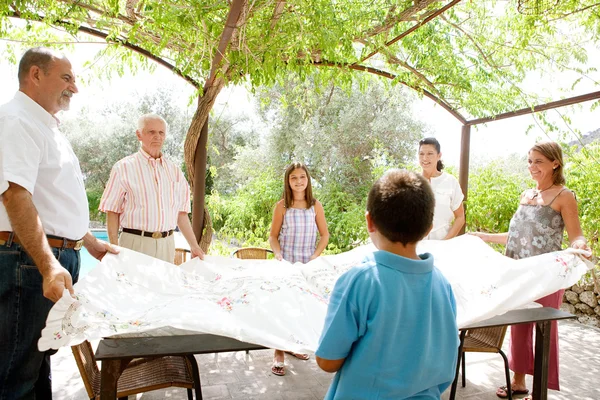 Family getting ready for eating lunch outdoors