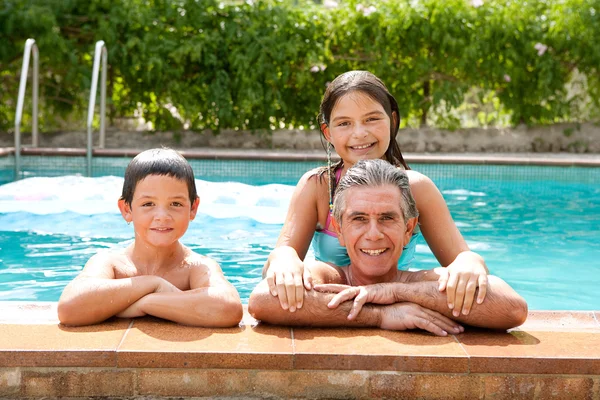 Family relaxing in swimming pool