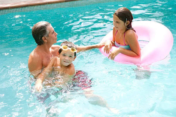 Family swimming together in a pool