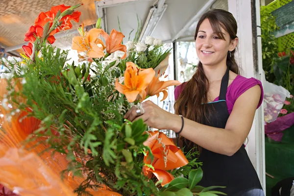 Florist woman works in her store