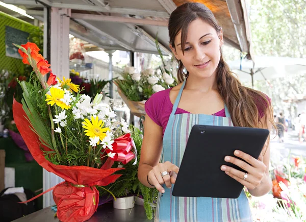 Florist woman with a clipbard in her store