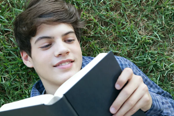 Student boy reading a boo