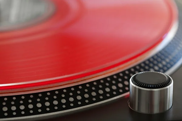 Red vinyl album on a professional dj turntable