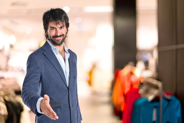 Businessman making a deal over white background