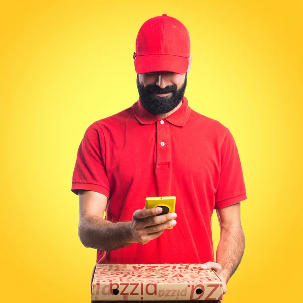 Pizza delivery man holding a mobile