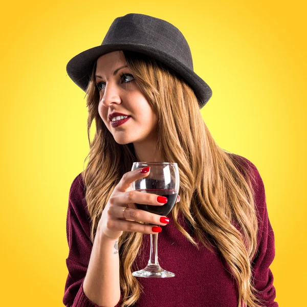 Hipster young girl holding a wine glass