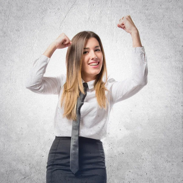 Young businesswoman winning on white background