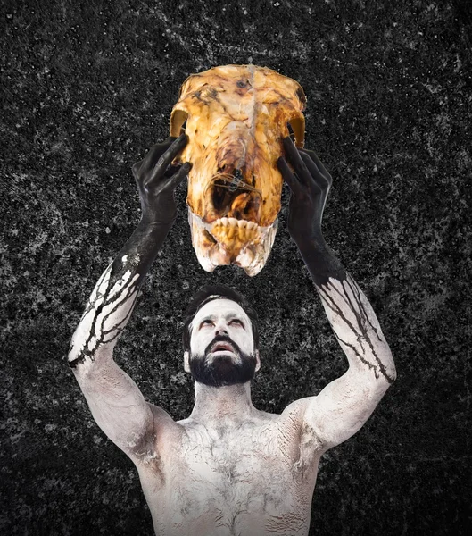 Primitive man offering veal skull
