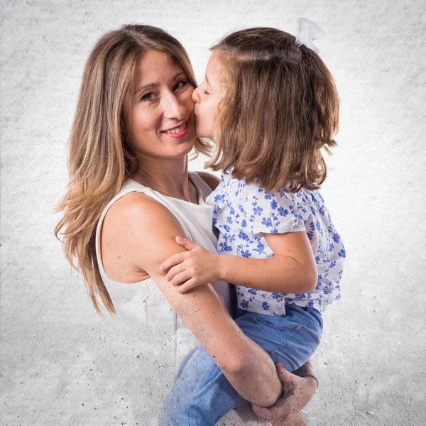 Daughter kissing her mother