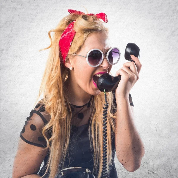 Pin-up girl talking to vintage phone