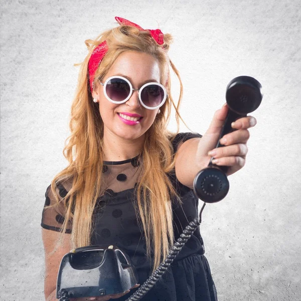 Pin-up girl talking to vintage phone