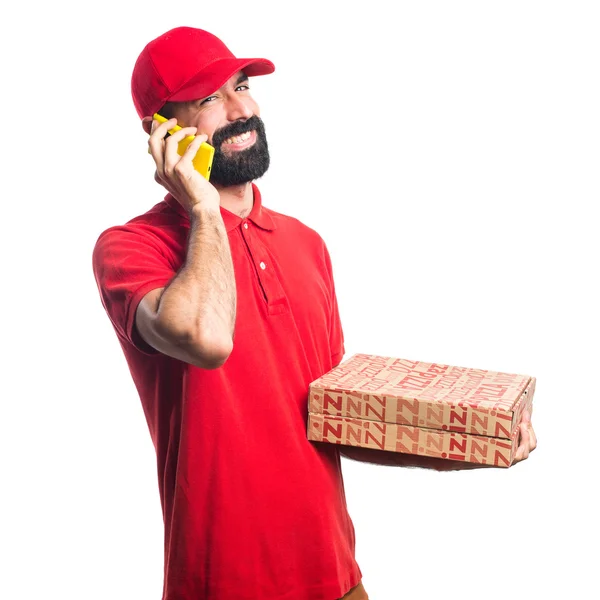 Pizza delivery man talking to mobile