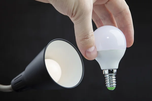 Install LED light bulb in lamp shade home light fixture.