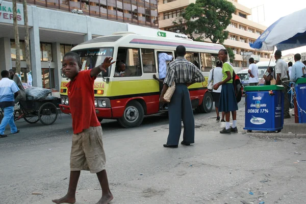 Passengers expect public transportation to the bus stop.