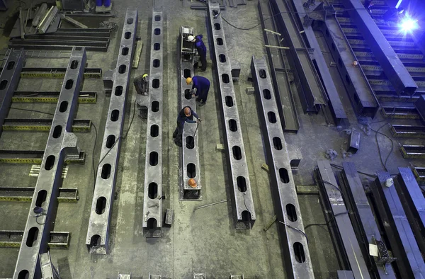 Steel construction beams are manufactured in production facilities metal factory.