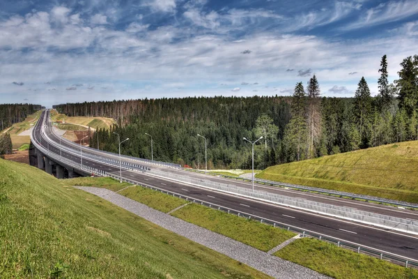 Speedway roadside storm drain ditch, stormwater drainage, Russian countryside.