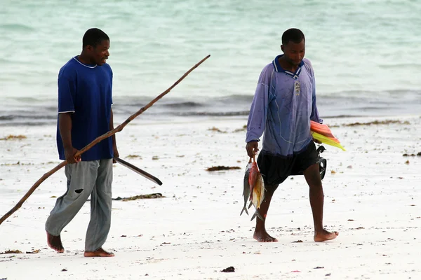 Two African fisherman divers return home with their catch.