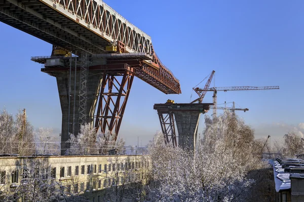 Construction overpass superstructure of road bridge over apartment house, Russia.