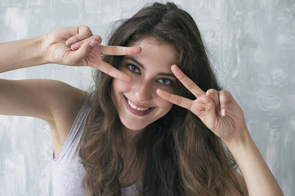 Portrait of happy girl showing peace signs