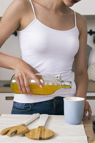 Close-up of unrecognizable woman pouring orange juice