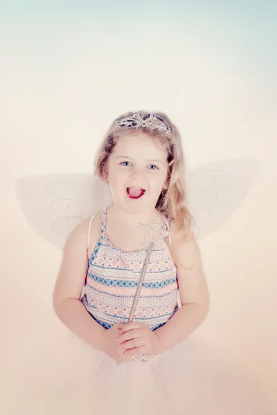 Smiling little girl with butterfly costume