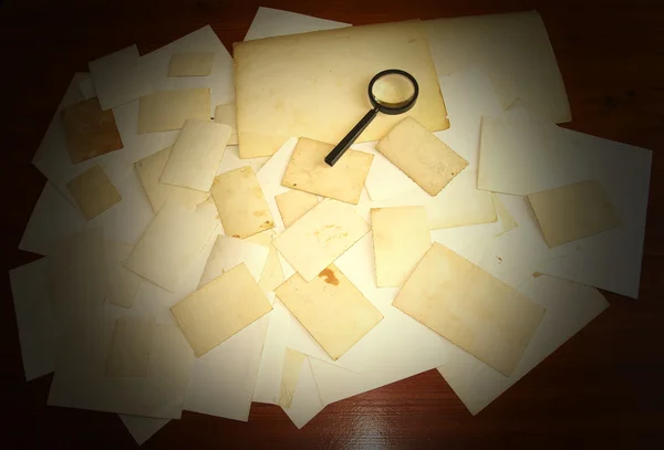 Vintage documents with magnifying glass