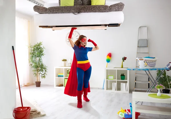 Sexy strong super hero woman holding bad in the air