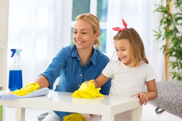 Worth families cleaning table with mop