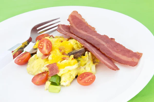 Scrambled Eggs Served With Two Slices of Fried Turkey Bacon