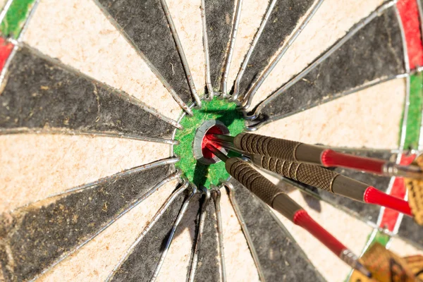 Darts board with 3 arrows in bullseye