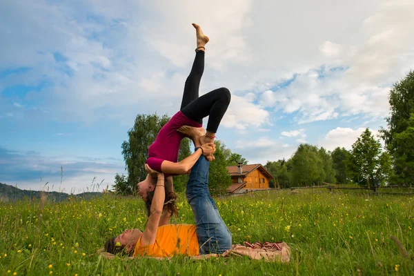 Positions Acroyoga girl of male in nature in the mountains