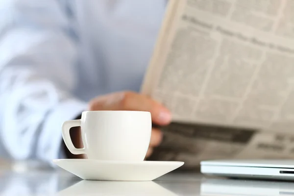 Cup of morning coffee with businessman on background