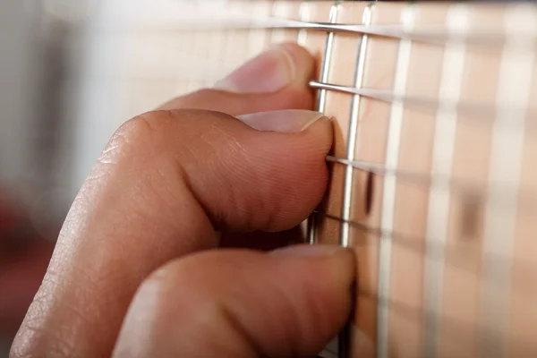 Hands of man playing electric guitar