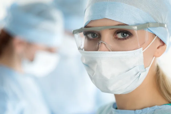 Close-up of surgeon woman looking at camera