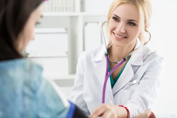 Female medicine doctor measuring blood pressure