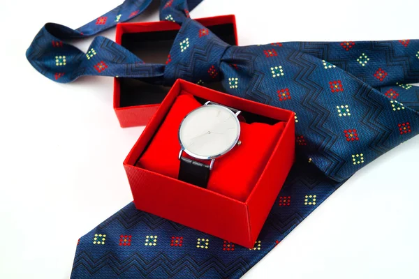 Classic business watches in red box and abstract blue necktie is