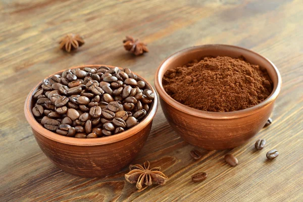 Bowls with coffee beans and ground coffee