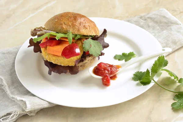 Vegetarian bean burgers with vegetables, served with sauce
