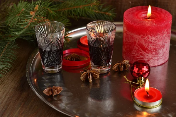 Christmas background with liquor, spices, candles and fir branches