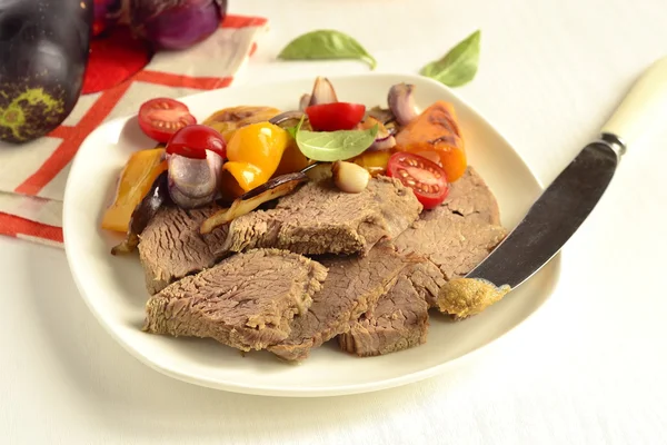 Boiled beef with baked vegetables