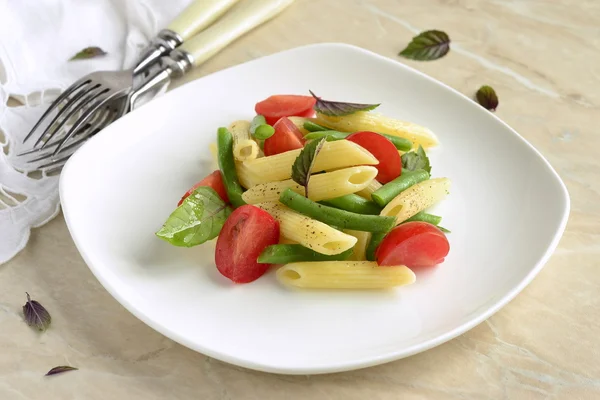 Penne pasta with green beans, cherry tomatoes and basil