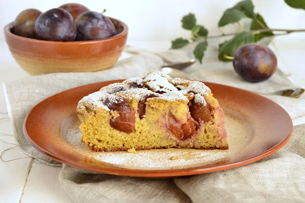 Slice of cake from corn meal with plums
