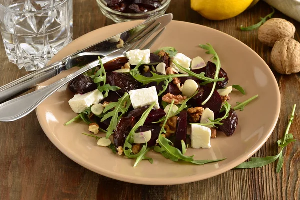 Beet salad with dried plums, walnuts, feta cheese and arugula