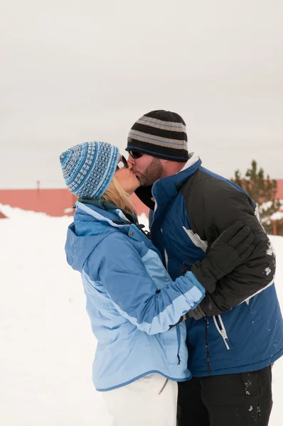 Beautiful couple kissing in the snow.